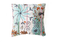 Unique suzani pillowcase 50x50 cm in white fabric with colorful floral ornament in turquoise, green, red and brown shades in ethnic boho style.